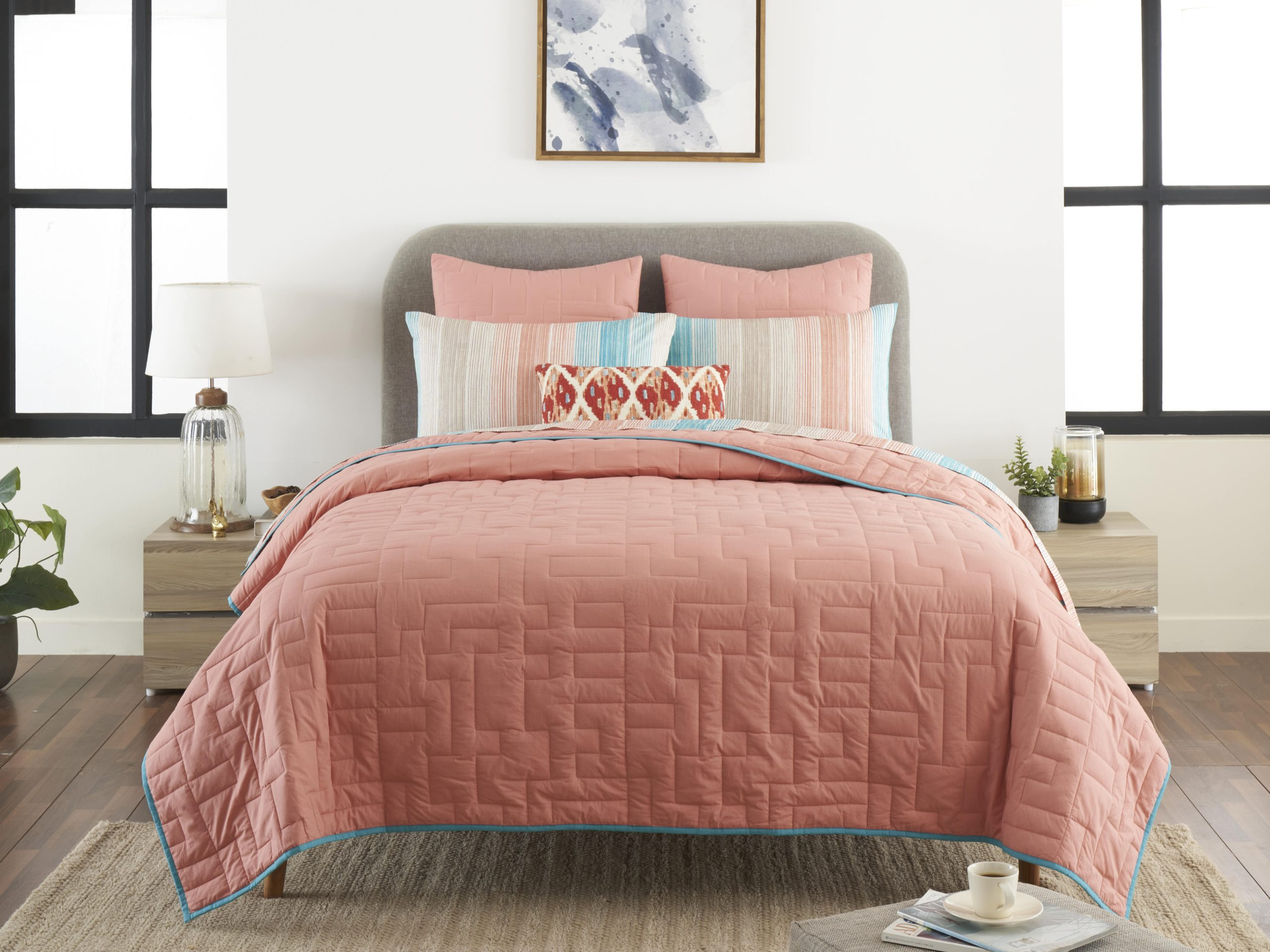 Bed with pink bedsheet in a room