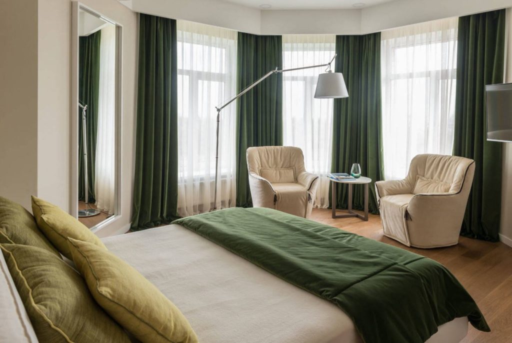 cozy bedroom with green curtain