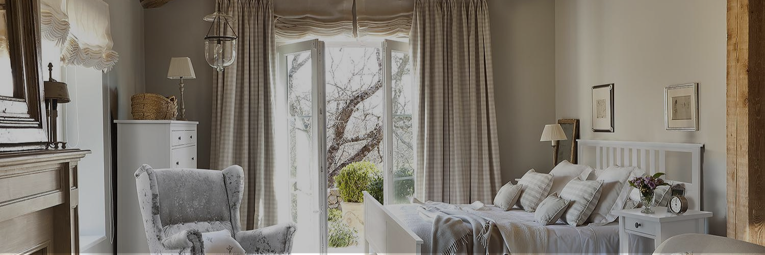 A cozy bedroom with beige color curtain