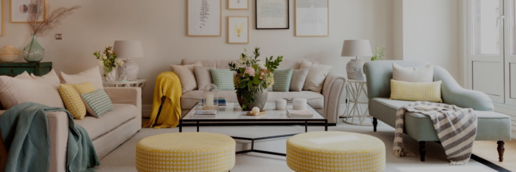 white color sofa with a table and two sofa stools in a cozy living room