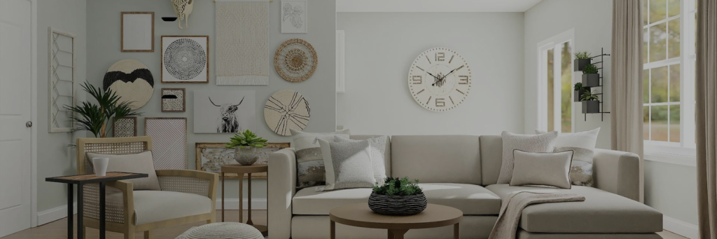 A stylish living room featuring a beige couch, decorative wall art, a round clock, and plants, creating a cozy atmosphere.